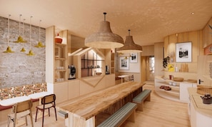 A modern kitchen with wooden countertops, hanging pendant lights, and a built-in bench.