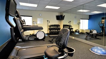 A fitness center with treadmills, exercise bikes, and free weights.