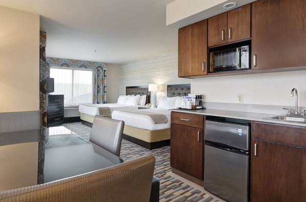 A hotel room with a dining area, kitchenette, and a bed with two pillows. - Holiday Inn Express Hotel & Suites Warwick-Providence (Arpt) by IHG (Warwick)