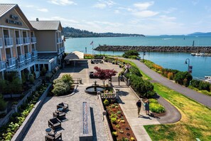 A hotel with a waterfront patio, outdoor seating, and a view of the lake.