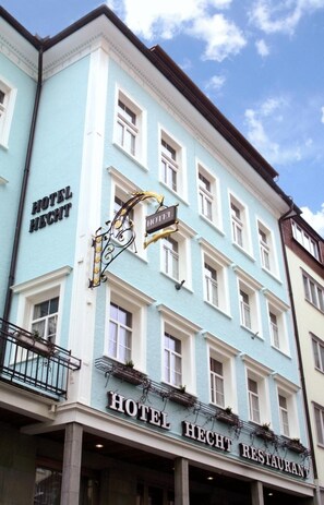 Experience the classic European charm of Hotel Hecht, featuring a restaurant and balcony with iron railing.