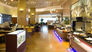 A spacious hotel lobby with multiple seating areas, a reception desk, and a coffee station. - New Otani Inn Sapporo (Sapporo)