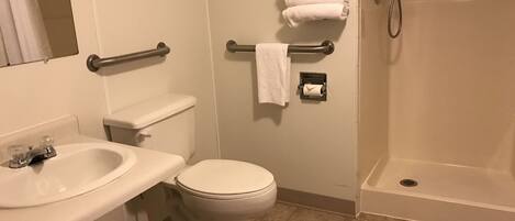 A bathroom with a sink, toilet, and shower.