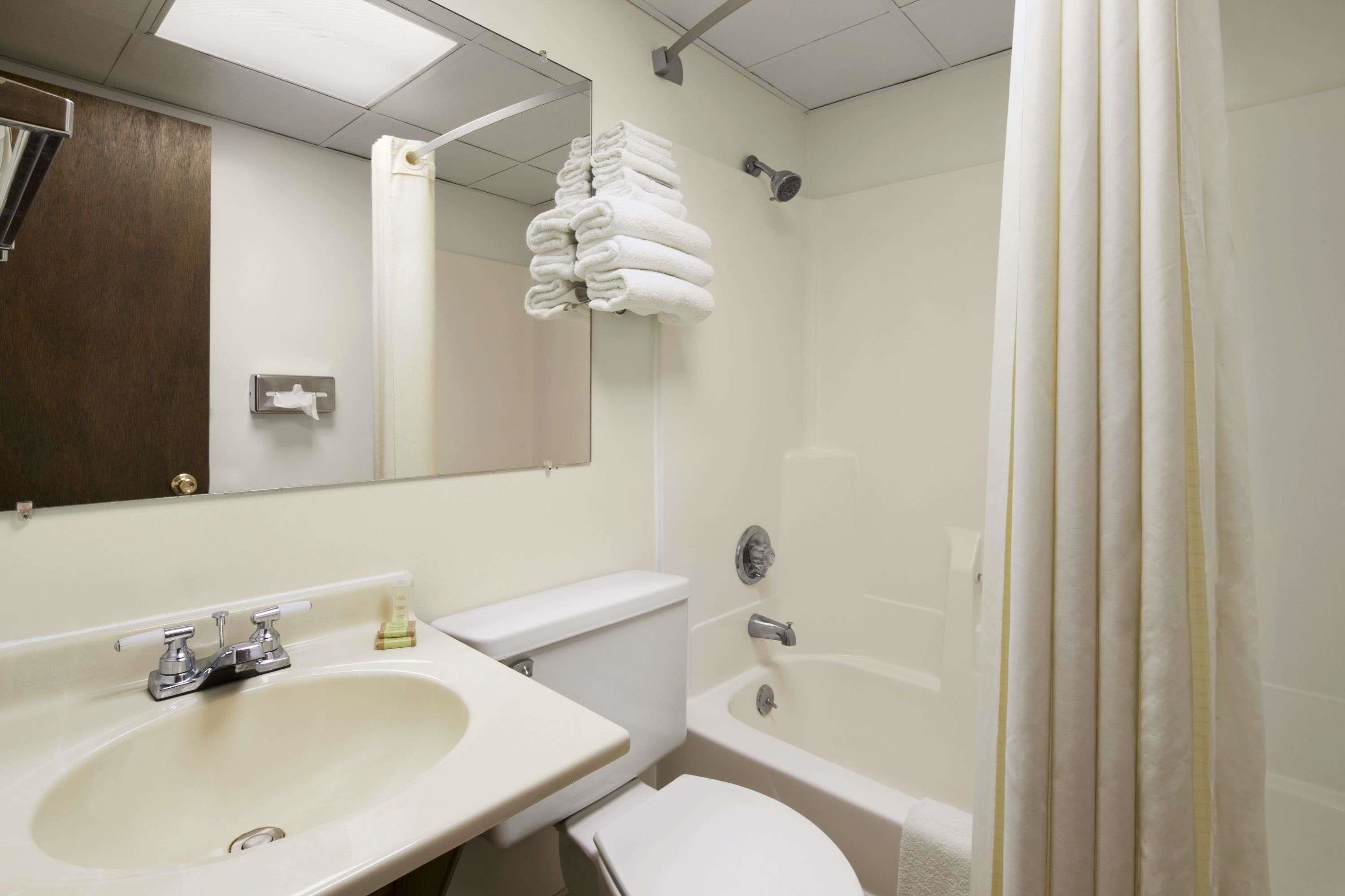 A bathroom with a sink, toilet, and bathtub.
