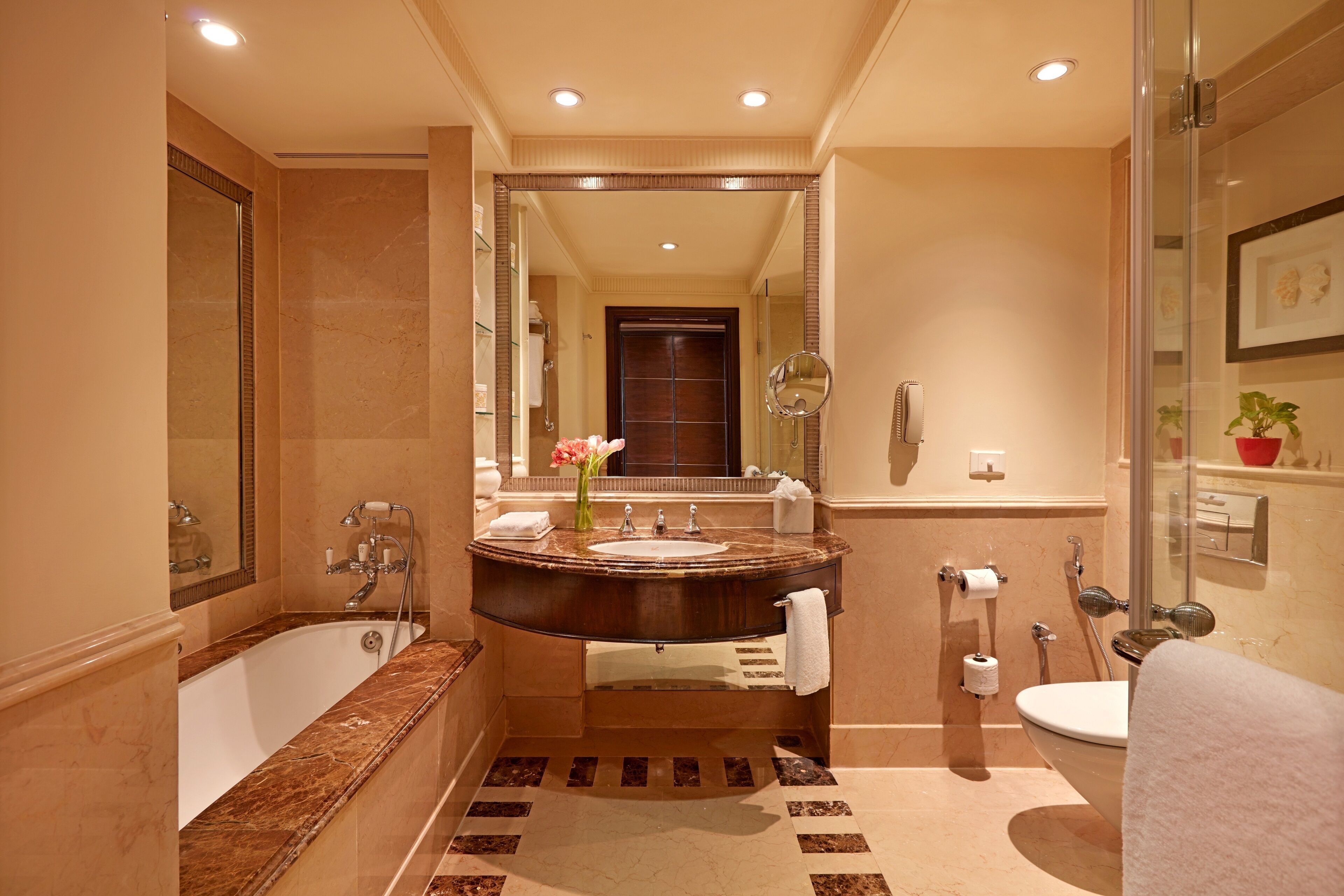 Une salle de bain moderne avec une baignoire sur pieds, un meuble-lavabo avec un miroir et des toilettes.