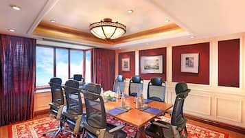 Conference room with a large table, office chairs, and artwork adorns the walls.