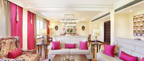 Un salón espacioso con un conjunto de sofás, un sillón estampado y una mesita de centro.