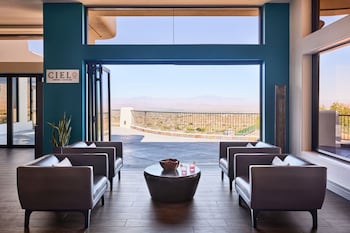 Relax in the lounge area with a stunning mountain view, surrounded by comfortable sofas and a central coffee table. at ADERO Scottsdale Resort, Autograph Collection