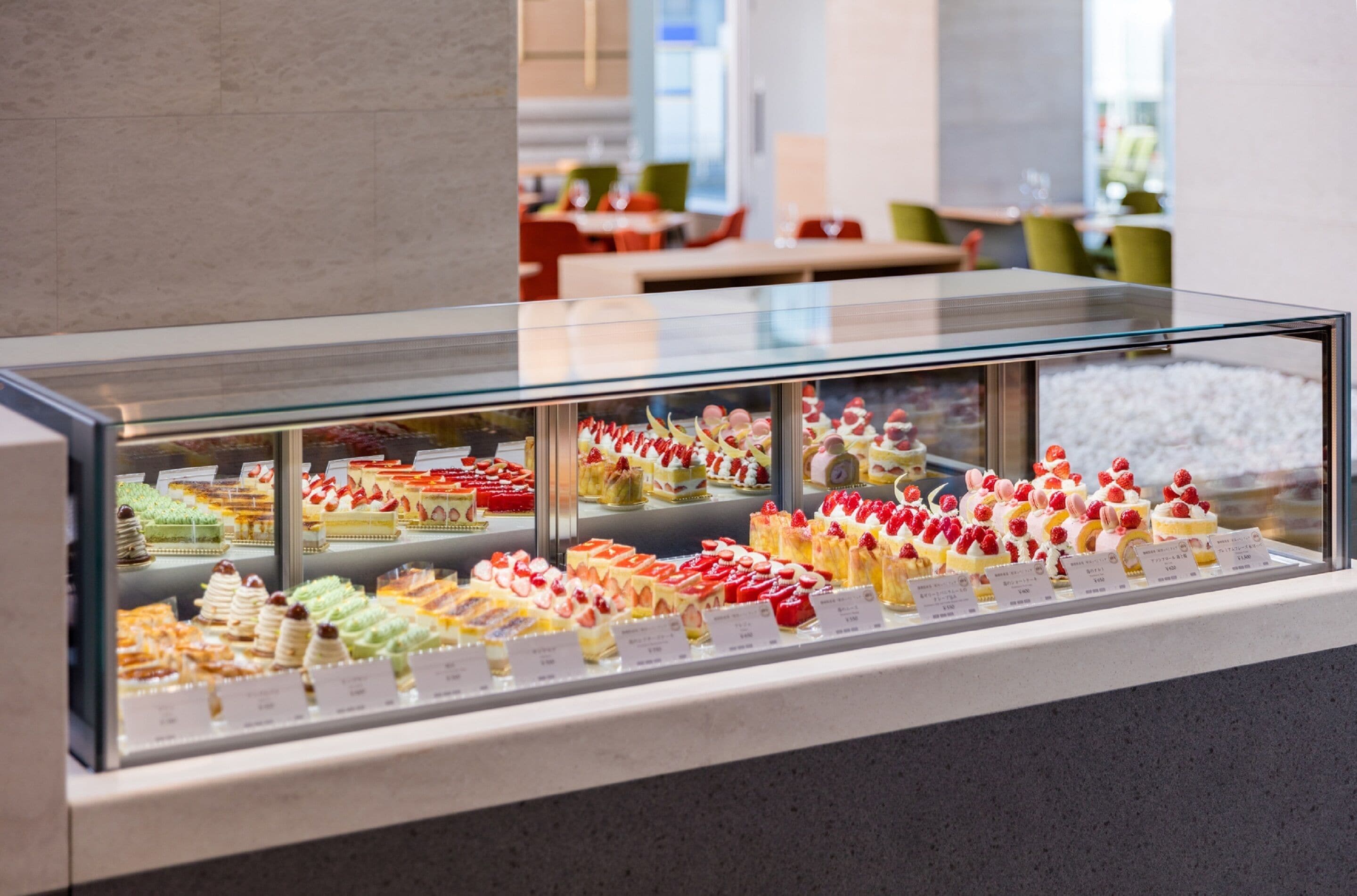 A display case of various desserts in a modern setting.