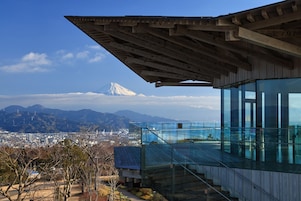 A modern building with large glass windows and a wooden structure.