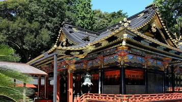 A traditional building with ornate roof decorations and a red and black color scheme.