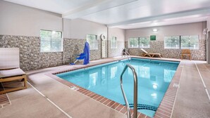 An indoor swimming pool with clear water, tiled walls, and a few lounge chairs. - Country Inn & Suites by Radisson, Pickerington, OH (Pickerington)