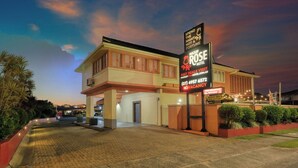 A hotel with a sign advertising 'Spend the night not a fortune' and 'Best deals visit'.