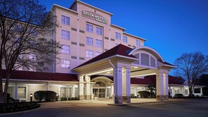 A Delta Hotels Marriott building with a covered entrance, large windows, and a prominent sign.