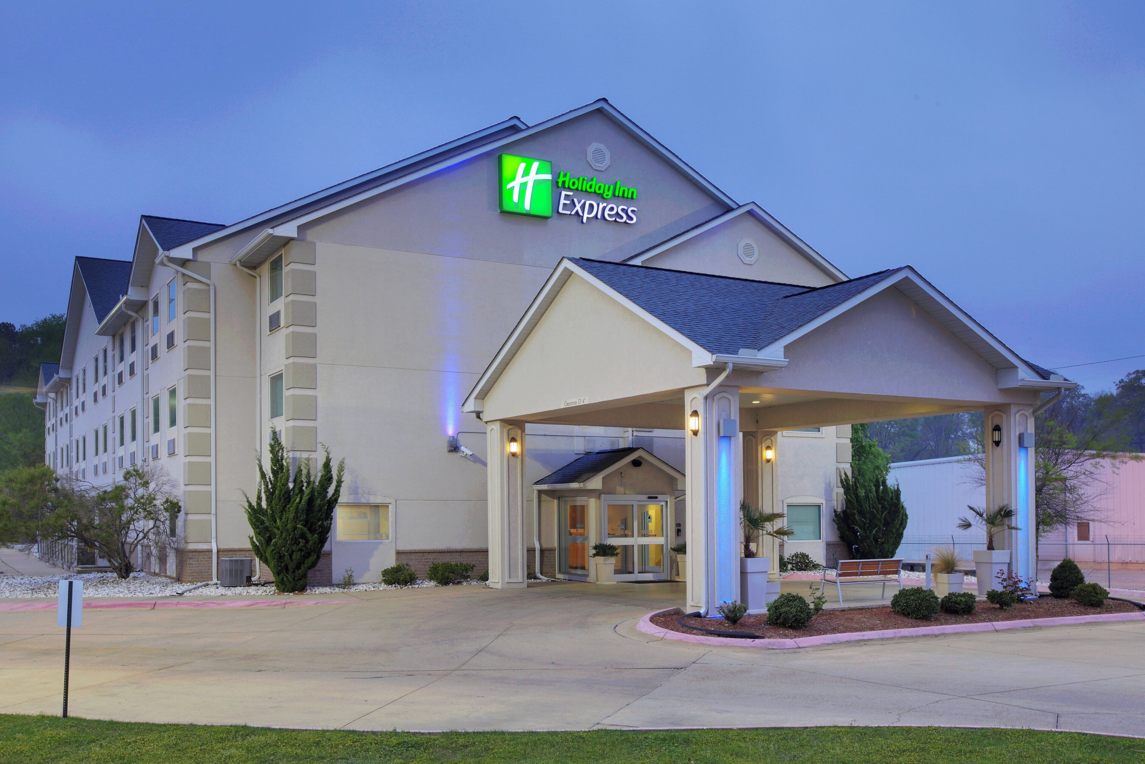 A Holiday Inn Express hotel with a covered entrance, multiple floors, and a landscaped front yard.