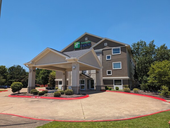 A Holiday Inn Express hotel with a covered entrance and a parking lot.