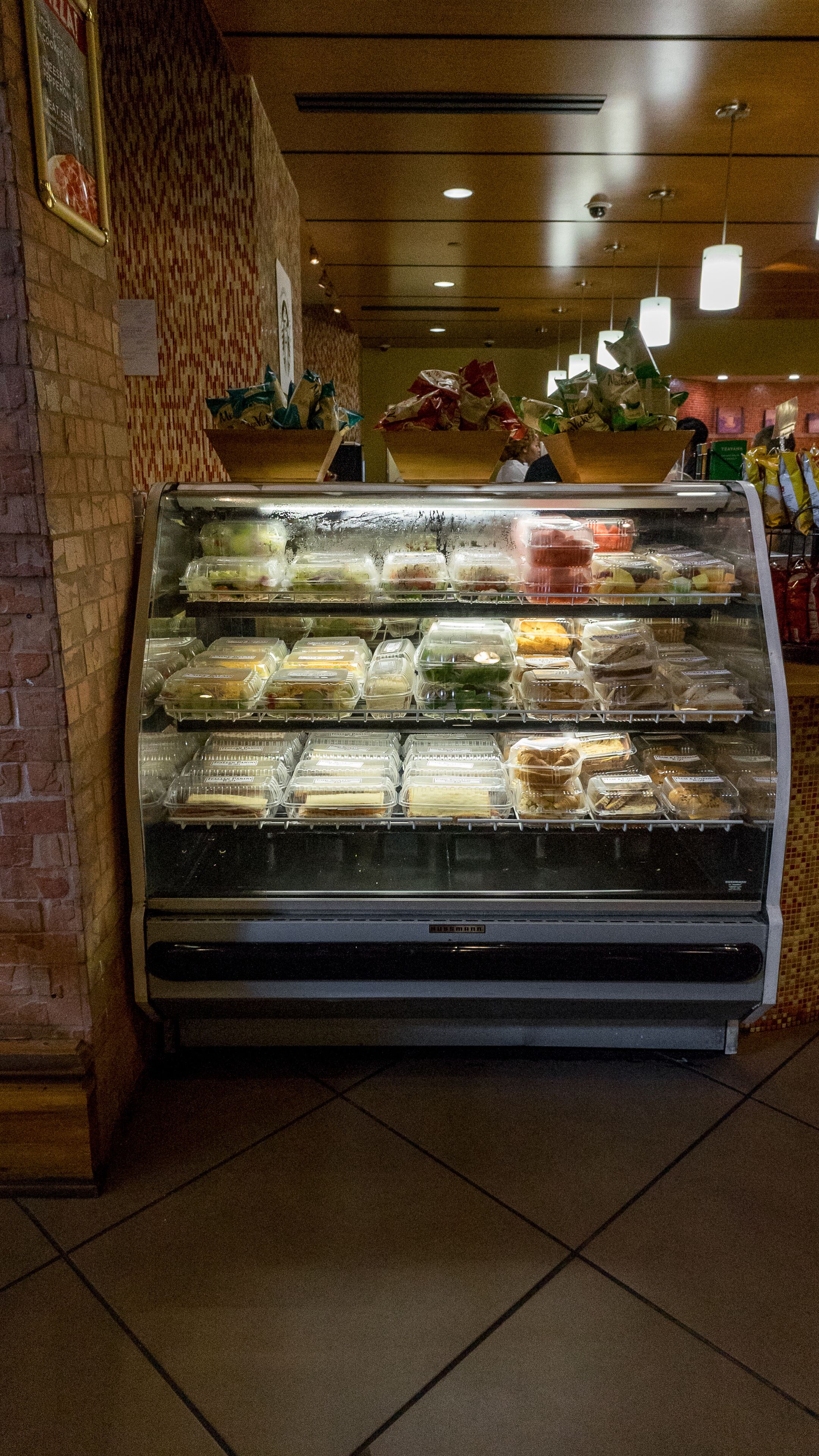 A deli case with various food items.
