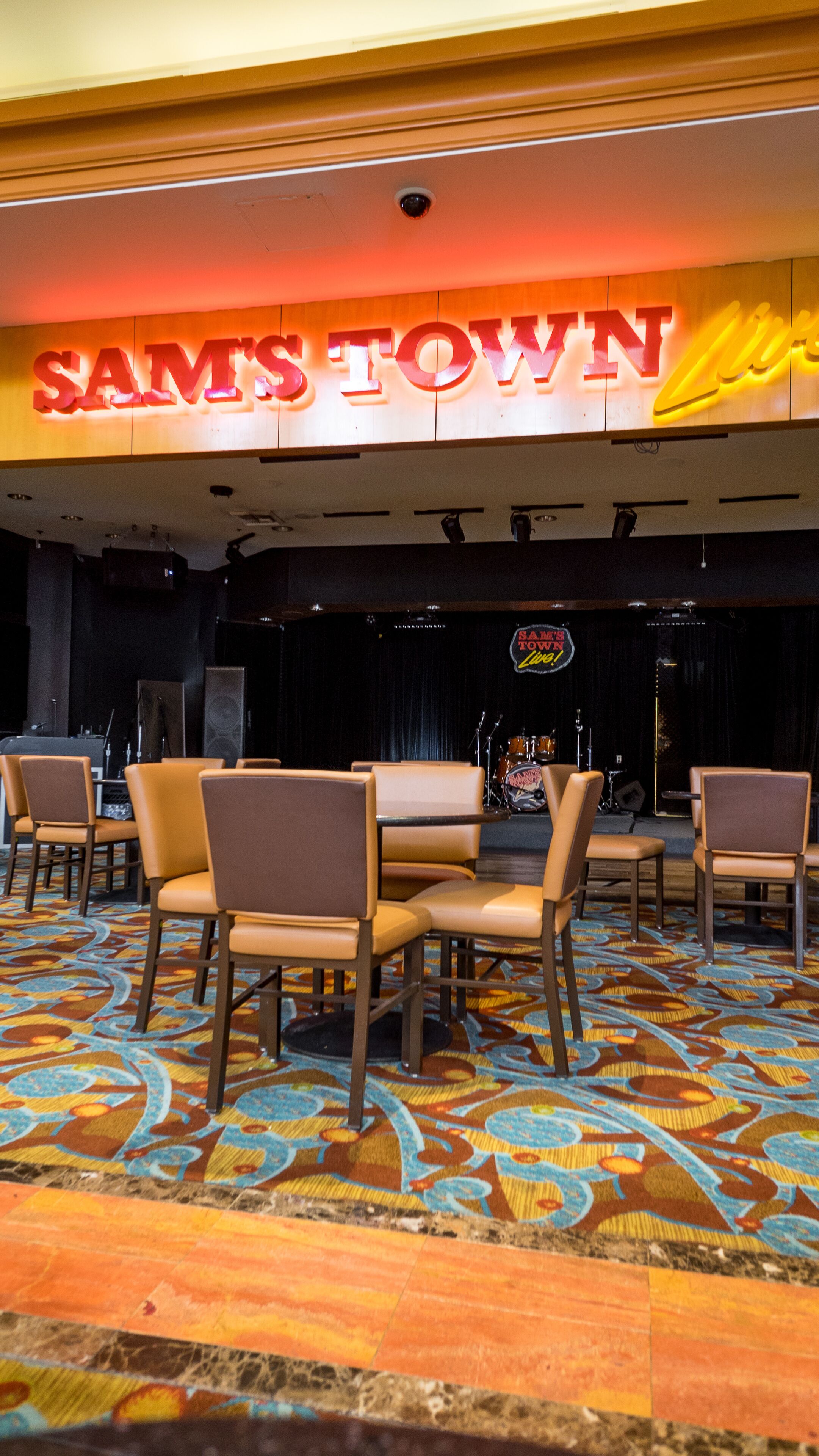 A hotel lobby with a stage and seating area.
