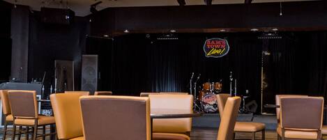A hotel lobby with a stage and seating area.