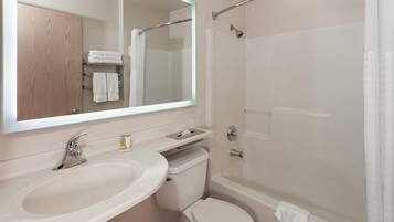 A bathroom with a sink, toilet, and shower.