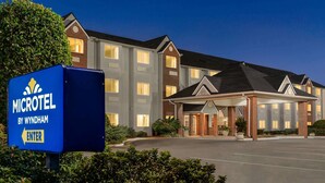 A microhotel by Wyndham with a brick facade, multiple windows, and a covered entrance. - Microtel Inn & Suites by Wyndham Tifton (Tifton)