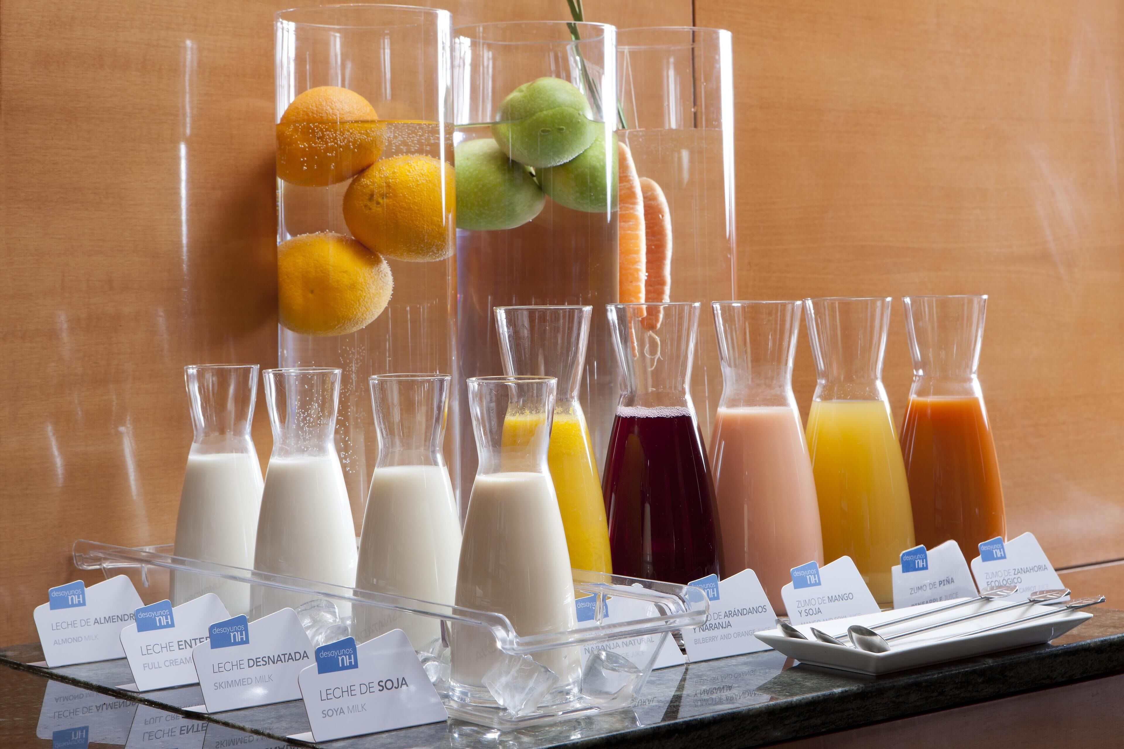 A variety of milk and juice dispensers with labels indicating different flavors.