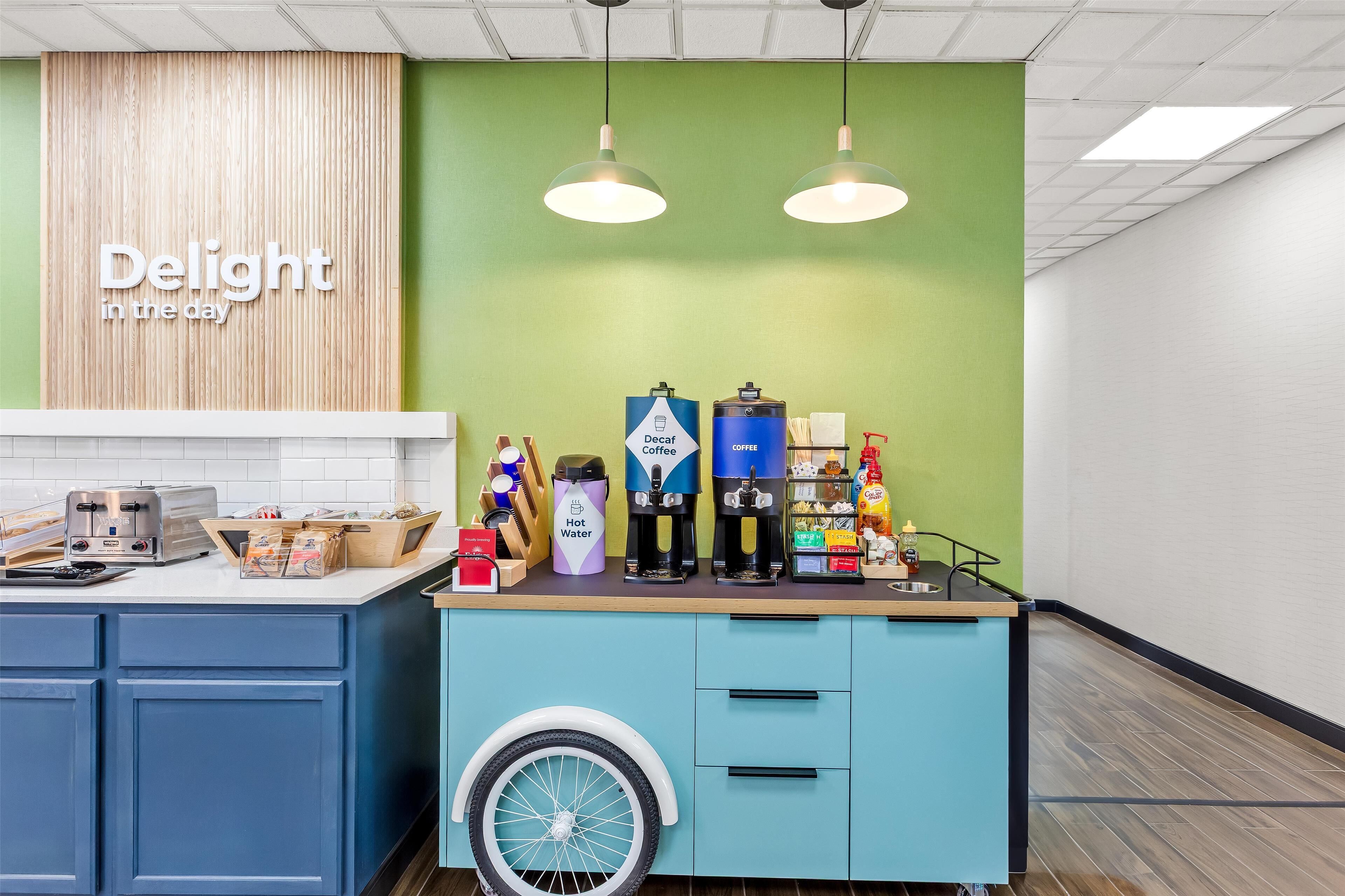 A coffee station with a toaster, coffee makers, and a water dispenser.
