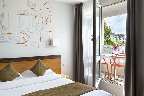 Relax in a spacious room with a large bed, city views, and a balcony.