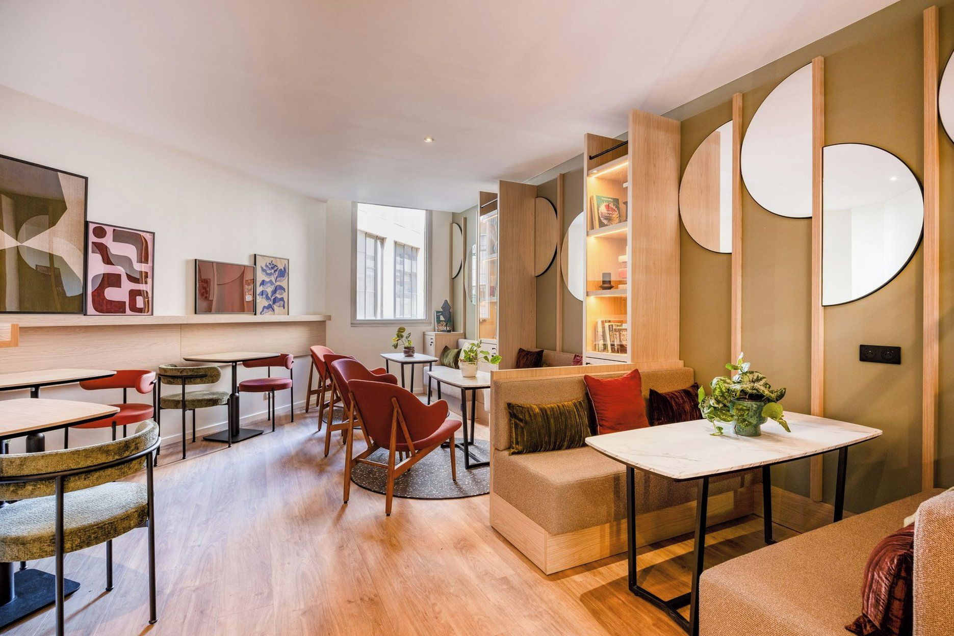 A modern living room with a sofa, chairs, a coffee table, and a dining area with a table and chairs.