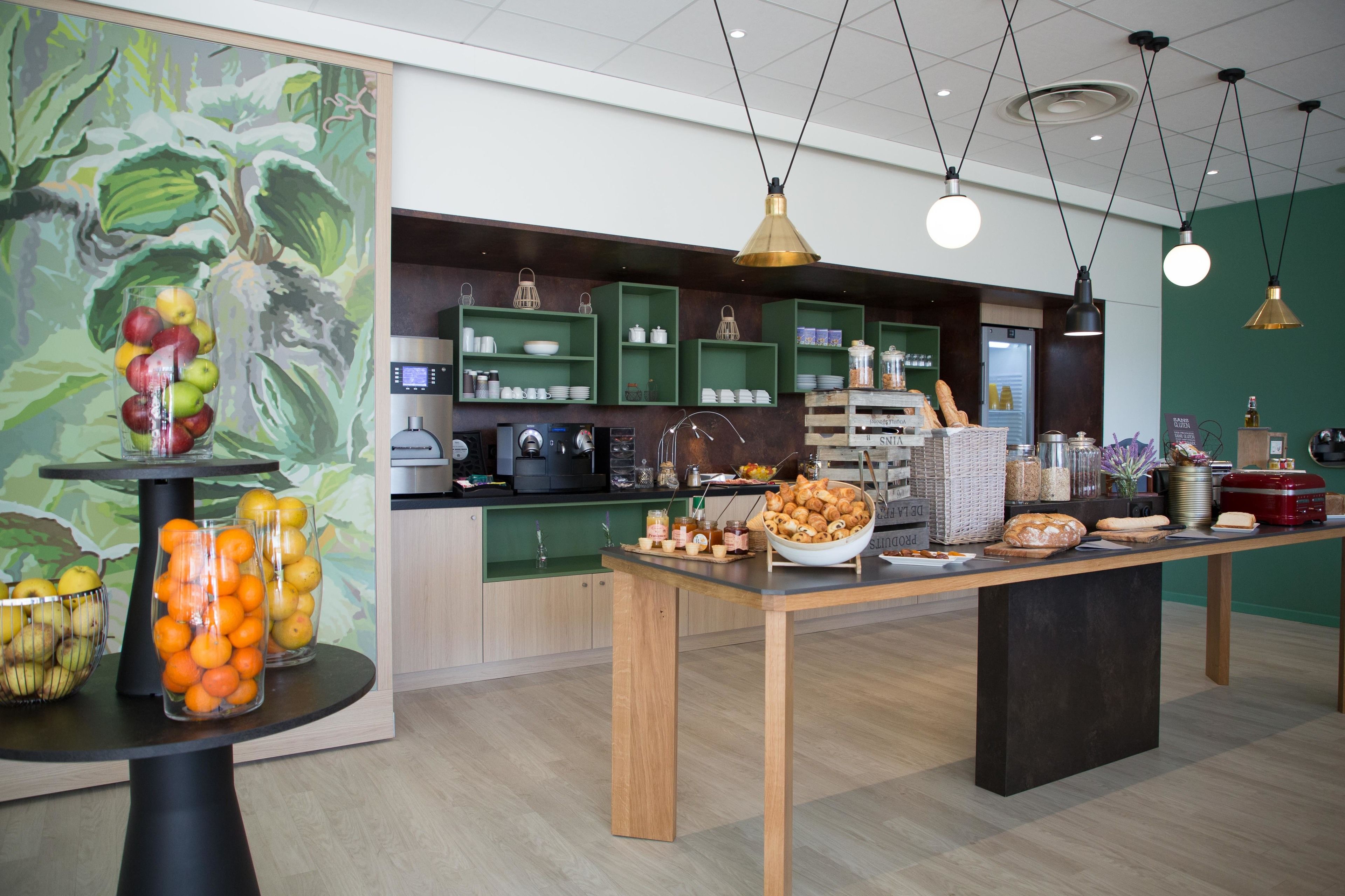 A buffet setup with various food items and a coffee station.