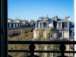 A view of a row of residential buildings with distinct architectural styles, including a prominent building with a mansard roof and dormer windows. - ibis Paris Ornano Montmartre Nord 18ème (Paris)