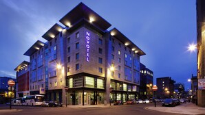 A modern hotel with a prominent 'NOVOTEL' sign, large windows, and a corner location with a street view. - Novotel Glasgow Centre (Glasgow)