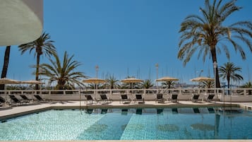 Outdoor pool, open 10:00 AM to 7:00 PM, pool umbrellas