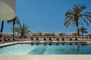 Outdoor pool, open 10:00 AM to 7:00 PM, pool umbrellas