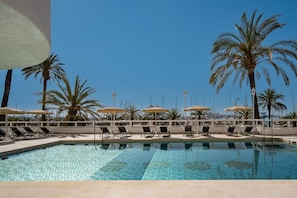 Outdoor pool, open 10:00 AM to 6:00 PM, pool umbrellas