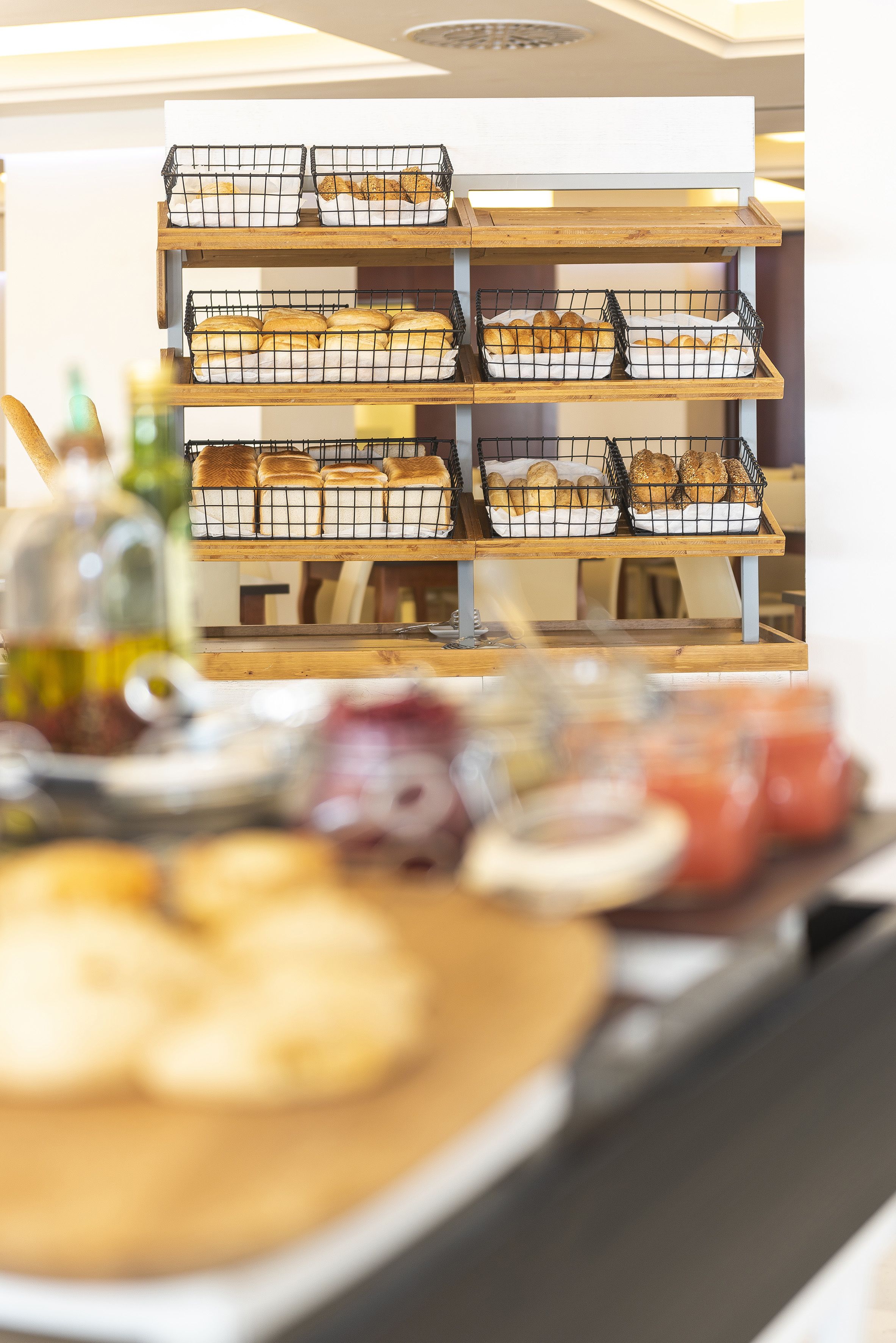 A bakery display with multiple trays of baked goods.