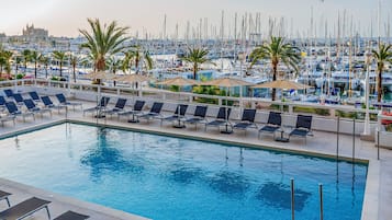 Outdoor pool, open 10:00 AM to 7:00 PM, pool umbrellas