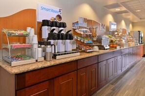 A buffet counter with coffee machines, cereal, and fruit options. - Holiday Inn Express Portland West/Hillsboro by IHG (Hillsboro)