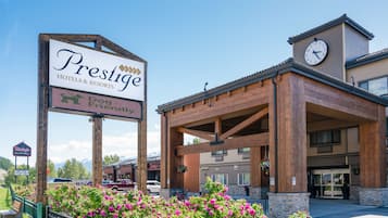 A hotel entrance with a sign indicating 'Prestige Hotels & Resorts' and 'Dog Friendly'.