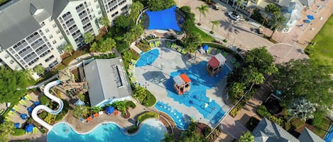 A resort with multiple swimming pools, a children's play area, and a variety of outdoor seating areas.