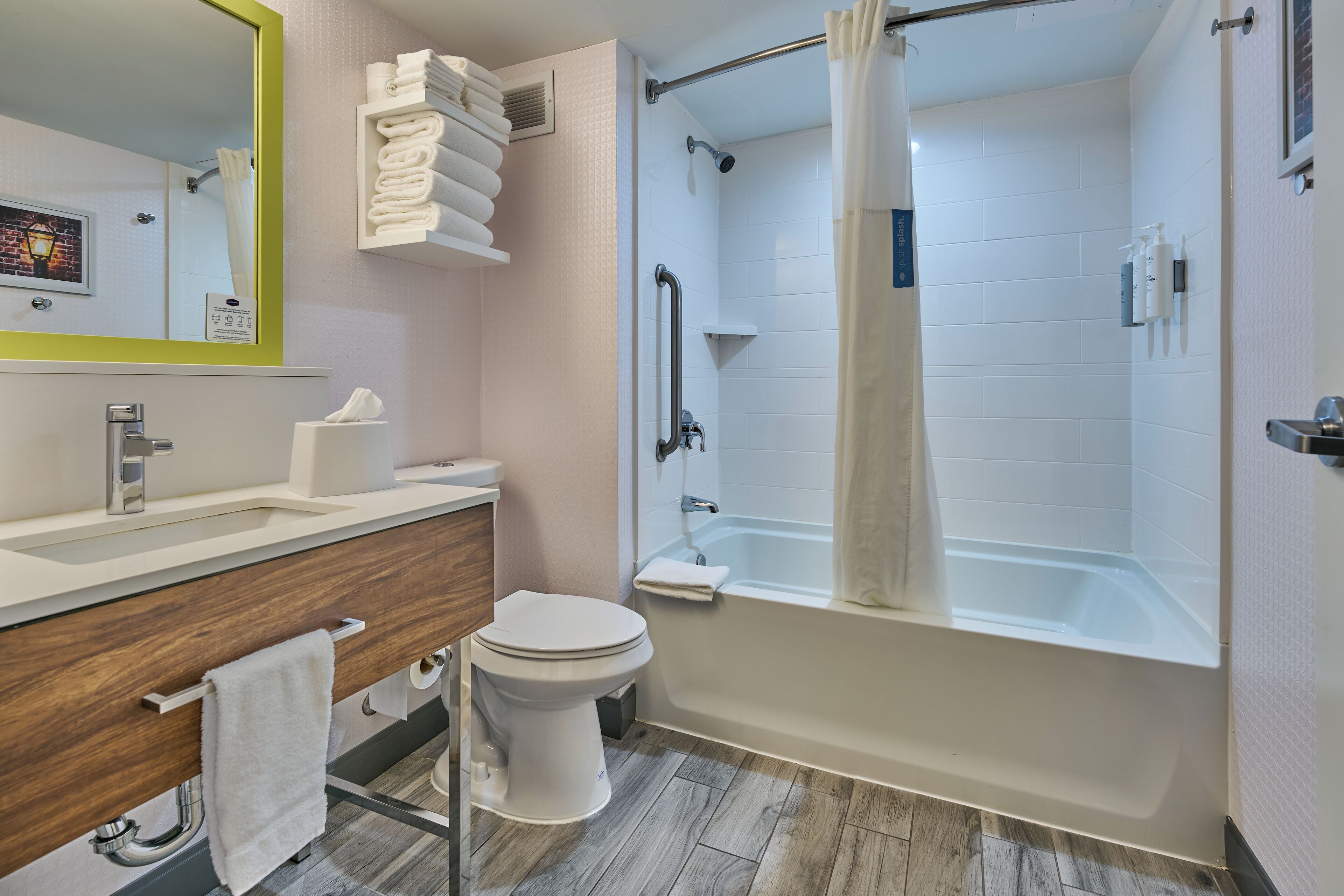 A modern bathroom with a white sink, toilet, and bathtub.