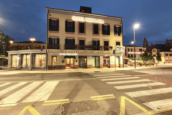 A hotel named "HOTEL PANORAMA" with a ground-floor restaurant and a visible entrance.