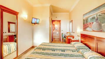 A hotel room with a large bed, a desk, a chair, a television, and a painting on the wall.