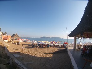 On the beach, sun-loungers, beach umbrellas, beach towels