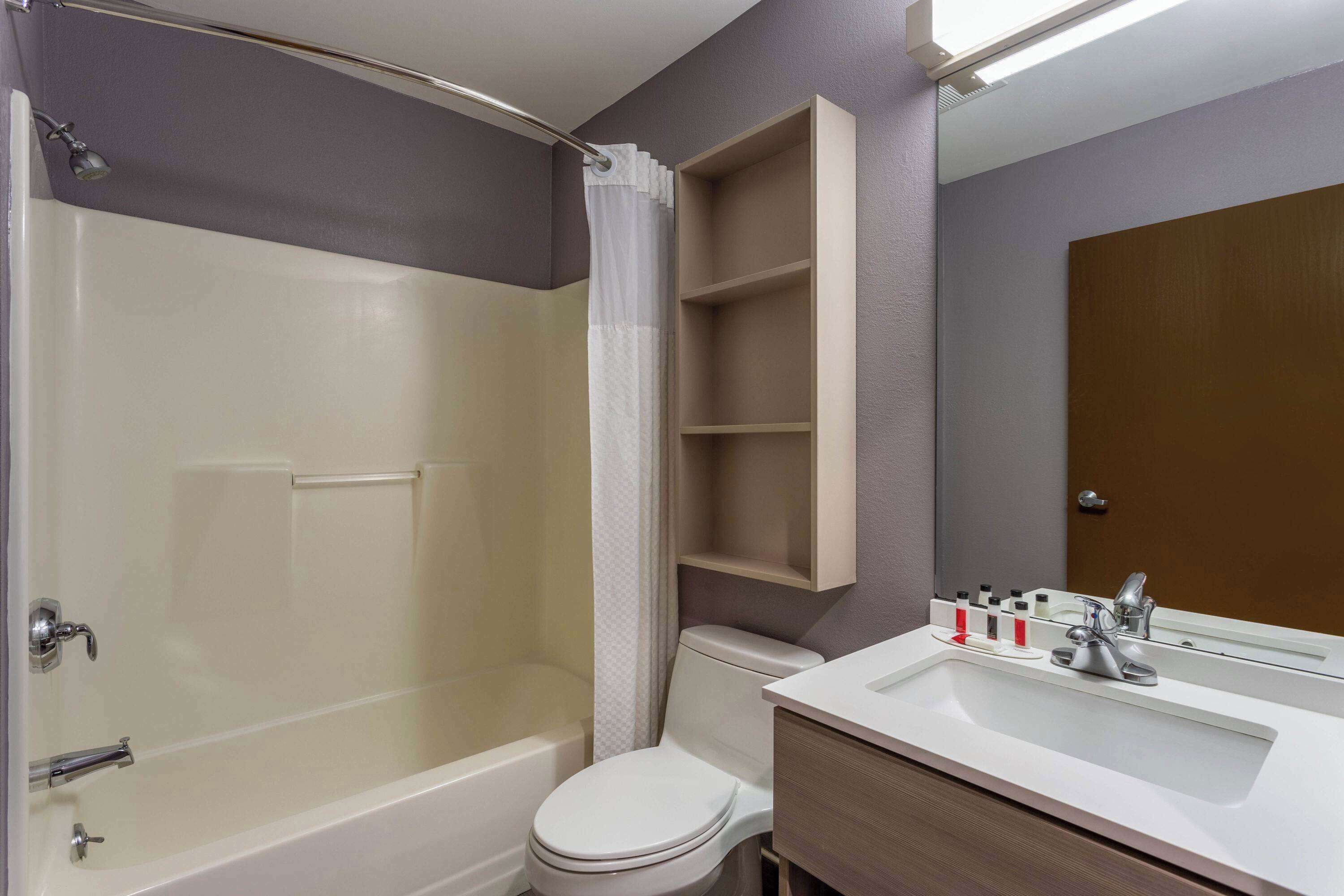 Un baño con bañera, inodoro y lavamanos.