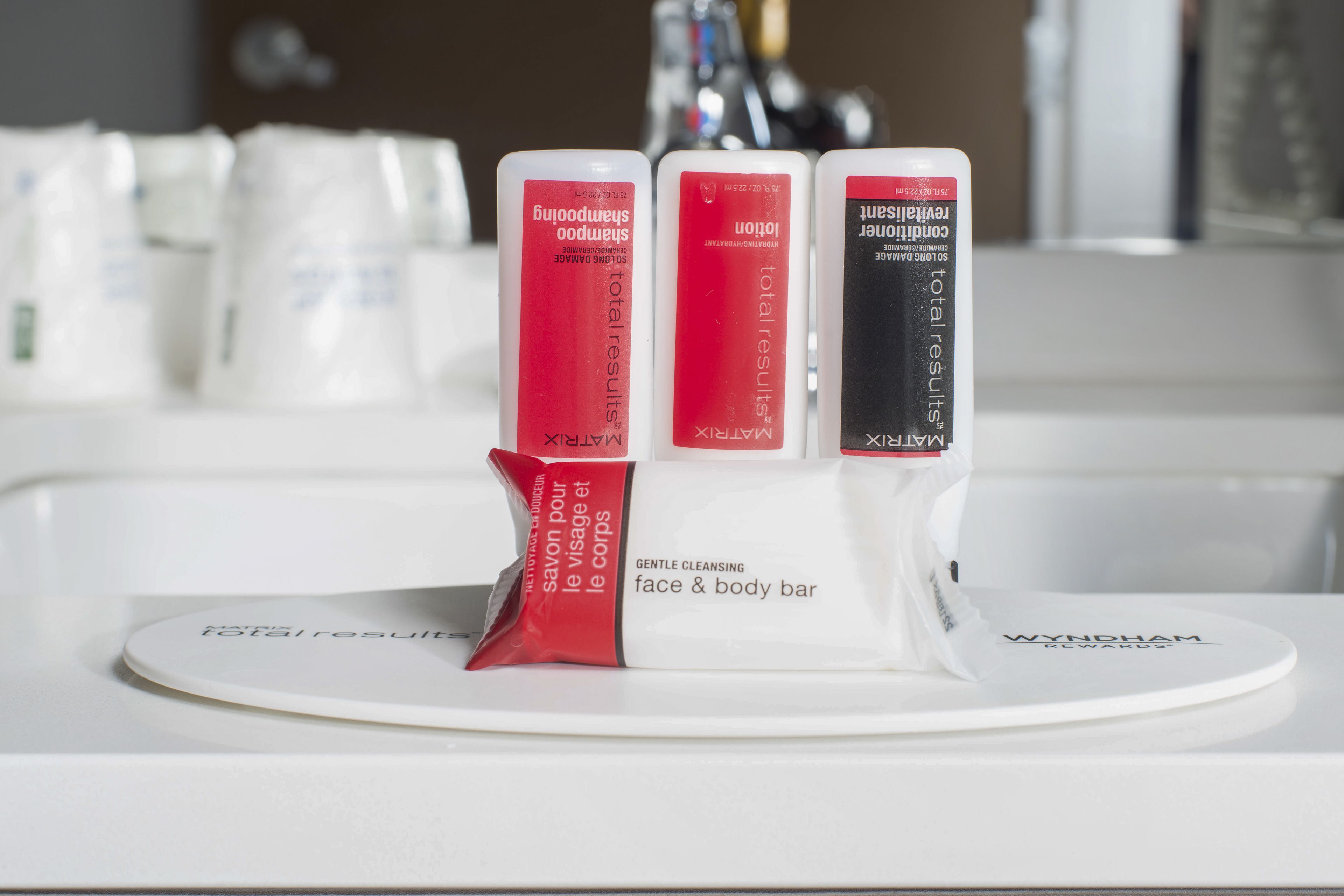 A white tray with three face and body bars labeled 'total results' on a white countertop.