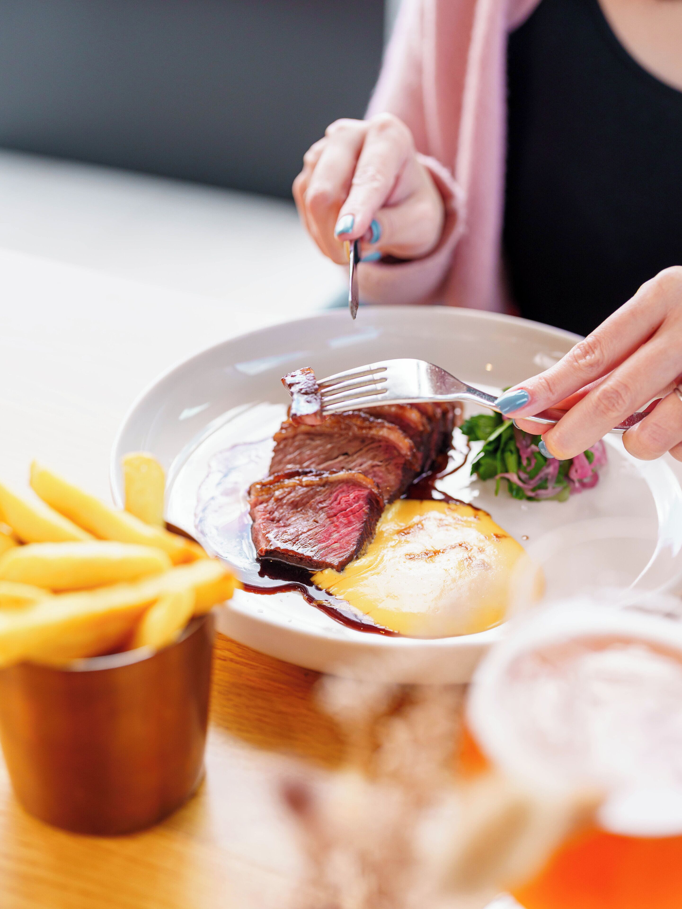 A plate with steak, fries, and a salad.