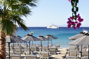 On the beach, beach shuttle, sun loungers, beach umbrellas