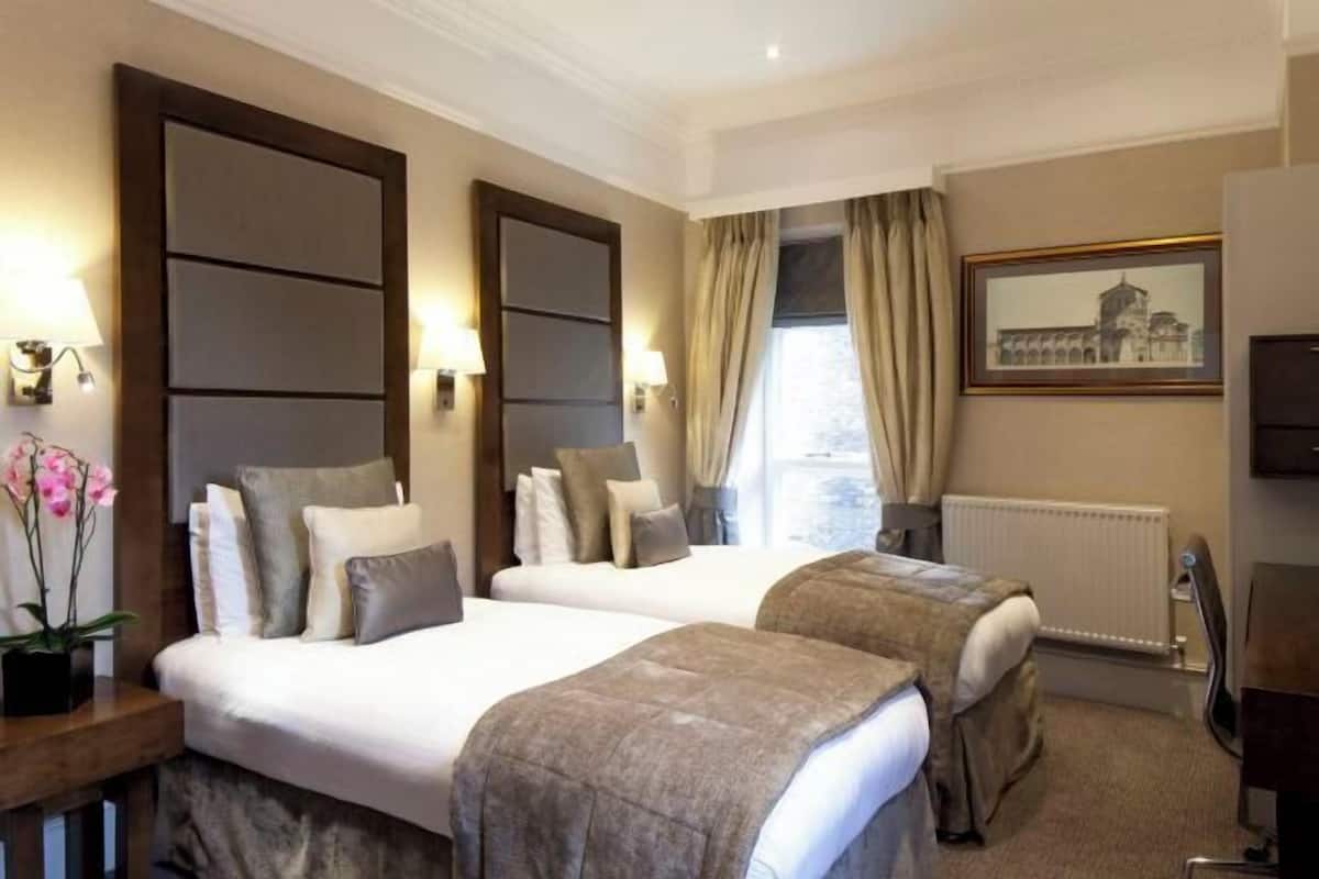 Ropa de cama hipoalergénica y caja de seguridad en la habitación