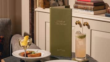 A table with a menu, a drink, and food items.